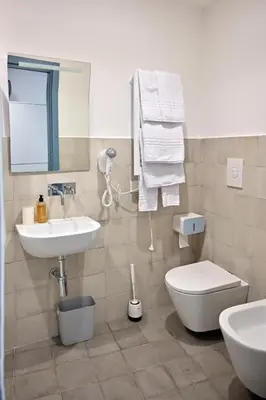 a bathroom with a toilet and a sink at Aria di Sale centro storico in Palermo