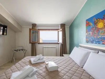 a bedroom with a large bed with towels on it at Apartment Pirandello by Interhome in Balestrate