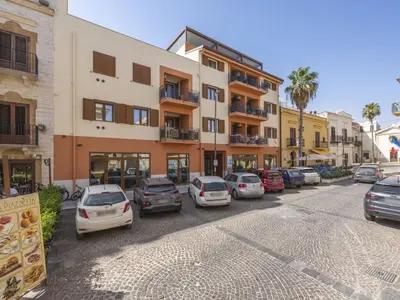 a street with cars parked in front of a building at Apartment Pirandello by Interhome in Balestrate