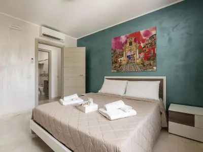 a bedroom with a large bed with two towels on it at Apartment A Lapa by Interhome in Balestrate