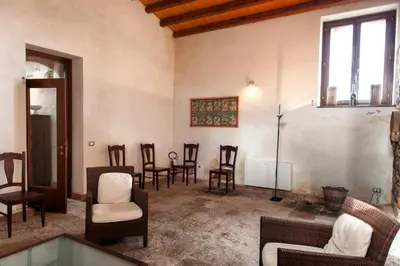 a living room with chairs and a table at Agriturismo Case Tabarani in Collesano