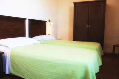 two beds sitting next to each other in a room at Agriturismo Case Tabarani in Collesano