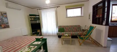 a living room with a bed and a couch at Casa Praiola in Terrasini