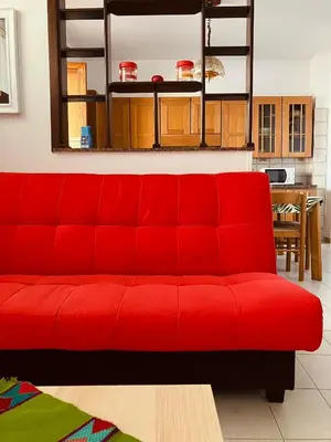 a red couch sitting in a living room at Casa Praiola in Terrasini