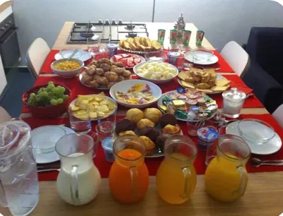 a table full of food and drinks on a table at B&B Giulio Cesare 24 in Palermo