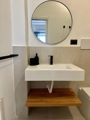 a bathroom with a white sink and a mirror at La Dimora Del Centro in Palermo