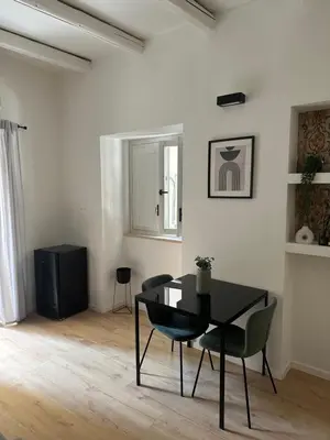 a dining room with a black table and chairs at La Dimora Del Centro in Palermo
