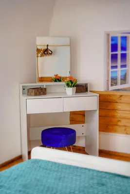 a bedroom with a desk and a blue stool at Sunflower Apartment in Palermo