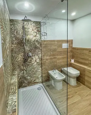 a bathroom with a shower and a toilet and a sink at Sunflower Apartment in Palermo