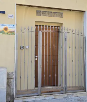 a gate in front of a building at Sunflower Apartment in Palermo