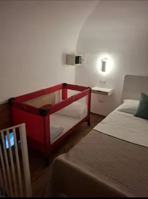 a bedroom with a red bunk bed next to a bed sidx sidx sidx at Sunflower Apartment in Palermo