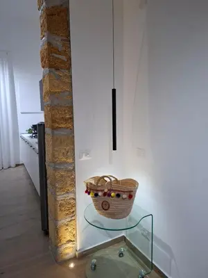 a basket on a glass table in a room at Donna Rosa House in Palermo