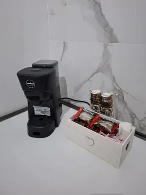 a coffee maker and a box on a counter at Donna Rosa House in Palermo