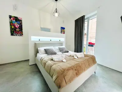 a large bed in a room with a large window at Pretoria Suites in Palermo
