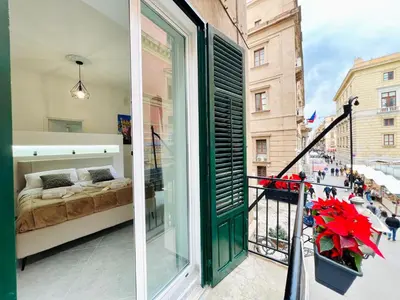 a balcony with a bed and a window at Pretoria Suites in Palermo