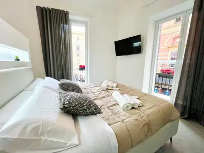 a bedroom with a bed with pillows and a window at Pretoria Suites in Palermo
