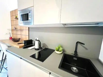 a kitchen with a sink and a microwave at Pretoria Suites in Palermo