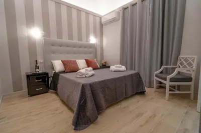 a bedroom with a bed with two towels on it at Scic House in Palermo