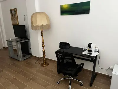a desk with a chair and a lamp in a room at Finestra del mare in Isola delle Femmine