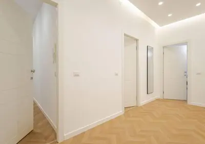 an empty hallway with white walls and wooden floors at Residenza Camillo - Palermo Centro in Palermo