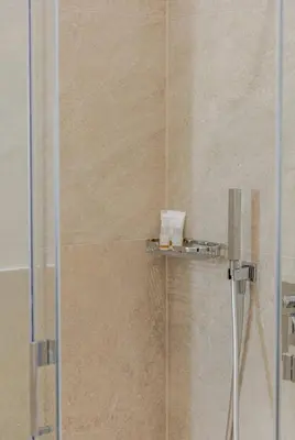 a shower with a glass door in a bathroom at Residenza Camillo - Palermo Centro in Palermo