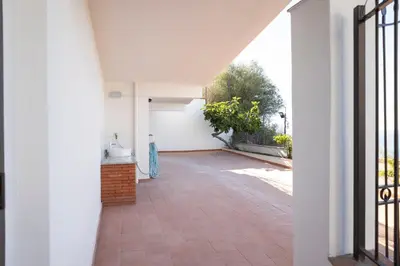an empty hallway of a white building with a patio at Trabia Villa Bedda Mia A in Trabia