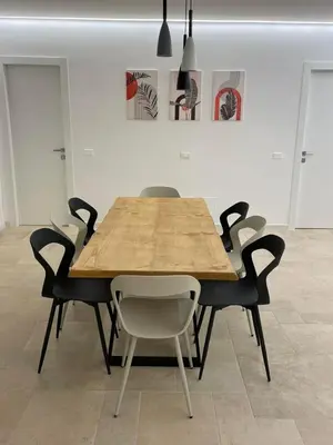 a wooden table and chairs in a room at #Secretplace in Palermo
