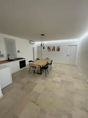 a dining room with a table and a kitchen at #Secretplace in Palermo