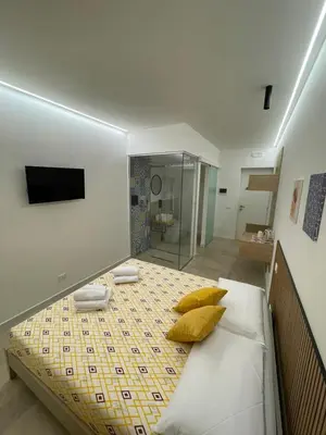 a bedroom with a bed with yellow pillows on it at #Secretplace in Palermo