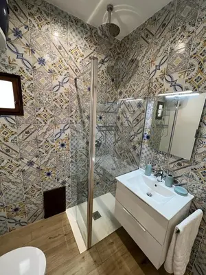 a bathroom with a sink and a shower at Two-room apartment in the heart of Palermo in Palermo