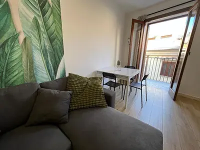 a living room with a couch and a table at Two-room apartment in the heart of Palermo in Palermo