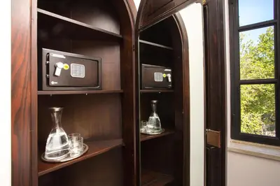a shelf with two glass vases and a tv at Appartamento La Torretta in Mondello