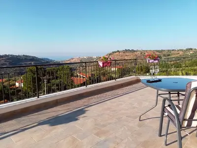 a patio with a table and chairs on a balcony at Holiday home 8 guests Granatelli in Altavilla Milicia