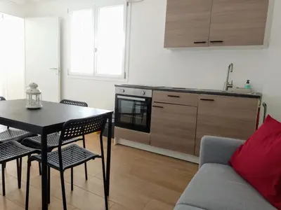 a living room with a table and a kitchen at Holiday home 8 guests Granatelli in Altavilla Milicia