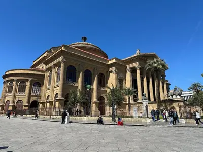 a large building with people walking in front of it at Massimo Boutique Apartment in Palermo