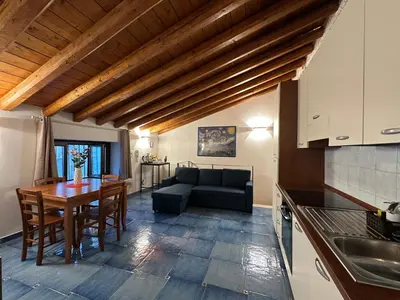 a kitchen and living room with a couch and a table at Massimo Boutique Apartment in Palermo