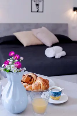 a table with a plate of bread and a vase at I tre Mori in Monreale