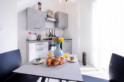 a kitchen with a table with a plate of croissants at I tre Mori in Monreale