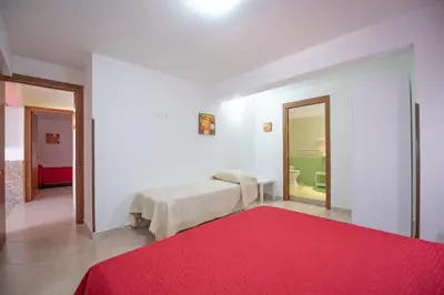 a bedroom with a bed and a red rug at A Casa di Amy in Macari