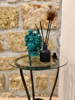 a glass table with a vase on top of it at Casa Faidda in Palermo