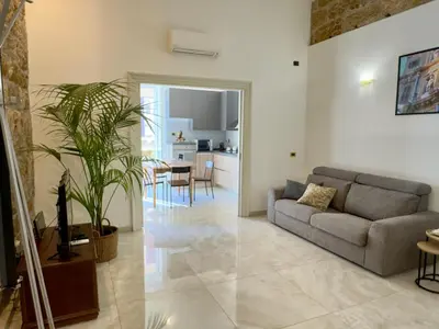 a living room with a couch and a table at Casa Faidda in Palermo
