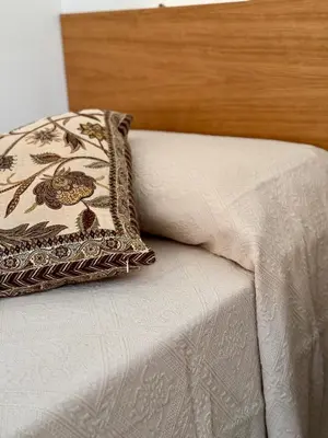 a pillow sitting on the edge of a bed at Casa Faidda in Palermo