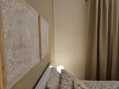 a picture hanging on a wall in a bedroom at Appartamento XII Gennaio 3 in Palermo