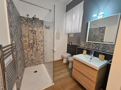 a bathroom with a shower and a sink and a toilet at Appartamento XII Gennaio 3 in Palermo