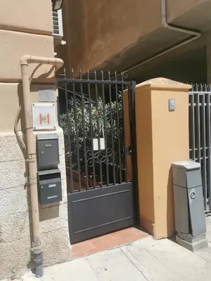 a black gate on the side of a building at Appartamento XII Gennaio 3 in Palermo