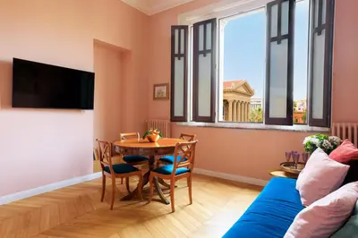 a living room with a table and a blue couch at Palermo al Massimo in Palermo
