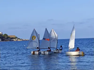 three small sailboats in the water on a lake at Casa sul mare Lalu a 20 kl da Palermo e 30 da Cefalu tre camere 9 posti in Santa Flavia