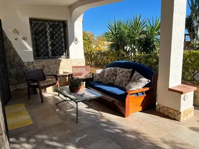 a couch and a table on a patio at Casa sul mare Lalu a 20 kl da Palermo e 30 da Cefalu tre camere 9 posti in Santa Flavia