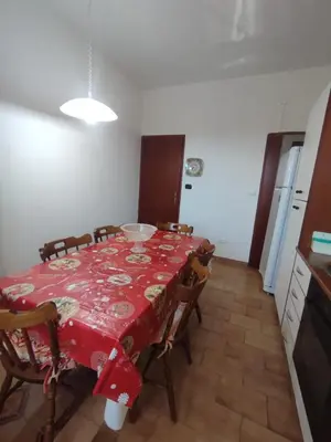 a dining room with a red table and chairs at Casa vacanze balestrate in Balestrate