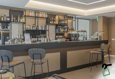 a rendering of a bar in a restaurant at HOTIDAY Mondello Beach in Mondello